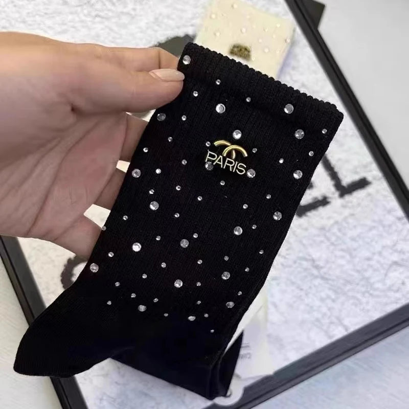 Luxurious Rhinestone socks for women, featuring a sophisticated black and white design and adorned with a chic metal label.