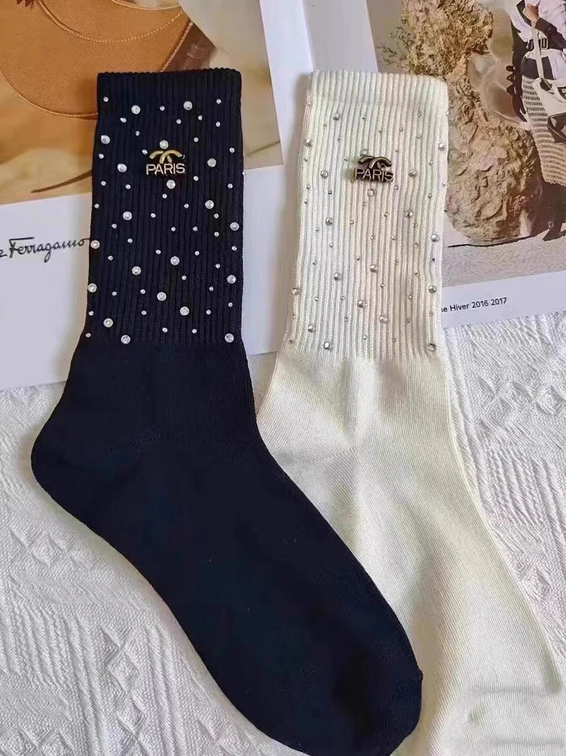 Luxurious Rhinestone socks for women, featuring a sophisticated black and white design and adorned with a chic metal label.