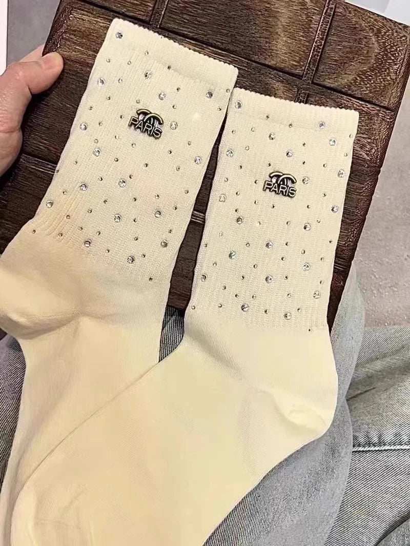Luxurious Rhinestone socks for women, featuring a sophisticated black and white design and adorned with a chic metal label.